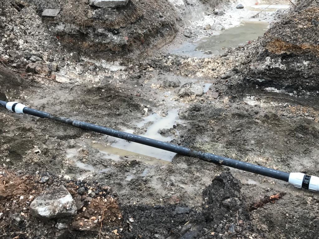 Replacement underground drain pipe installed during repair